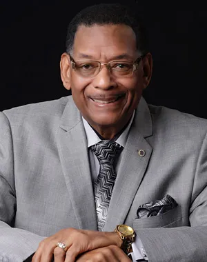 Headshot image of CWA President Claude Cummings Jr. in a gray suit